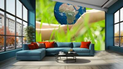 earth in children`s hands Wall mural